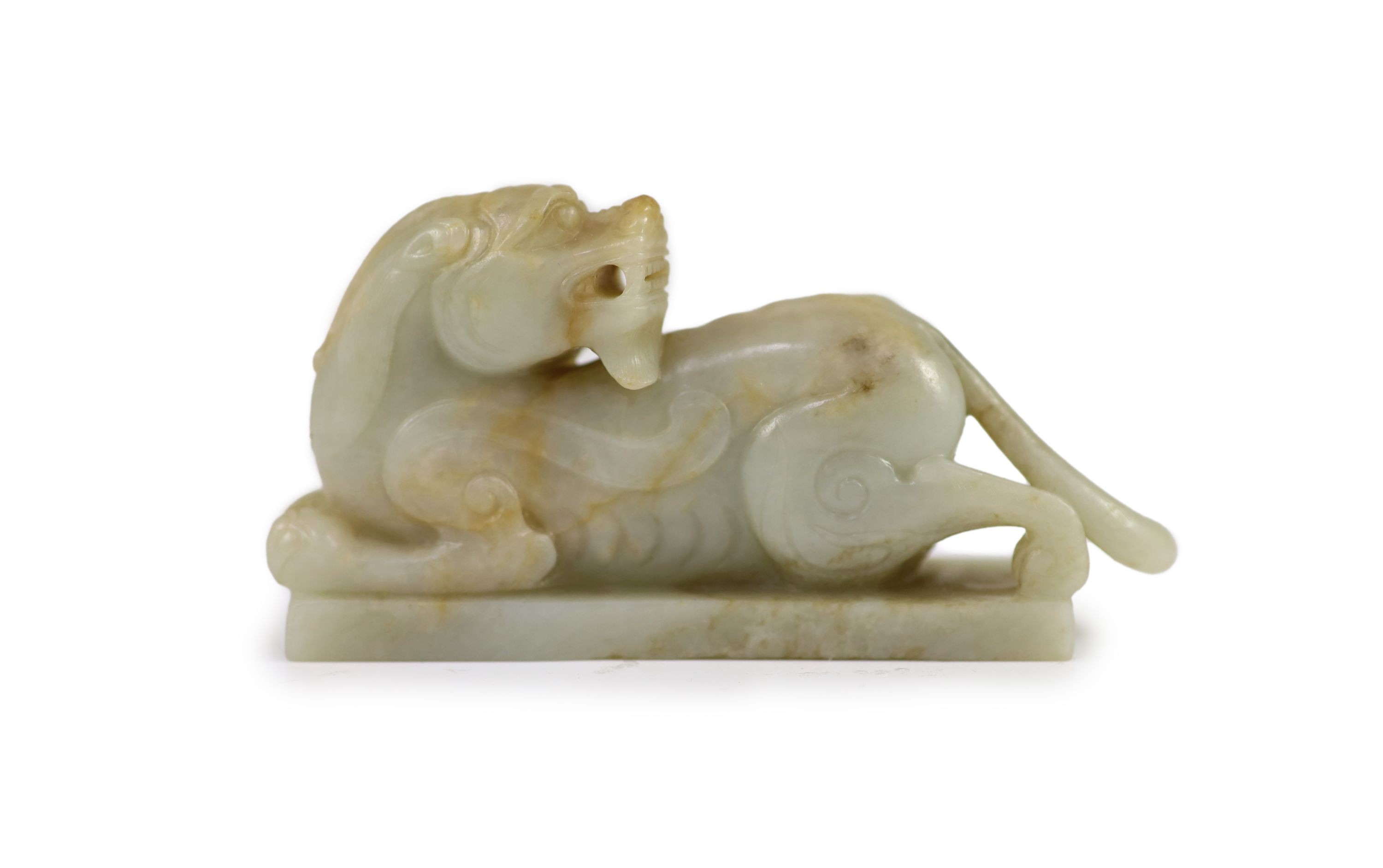 A Chinese Ming archaistic pale celadon and russet jade figure of a pixiu, 16th/17th century, 11.5cm long